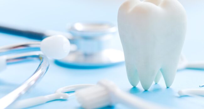 Dental model and dental equipment on blue background, concept im Dental model and dental equipment on blue background, concept im